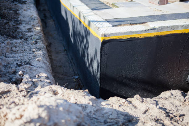 Professional Basement Waterproofing technician working in New Castle, AL